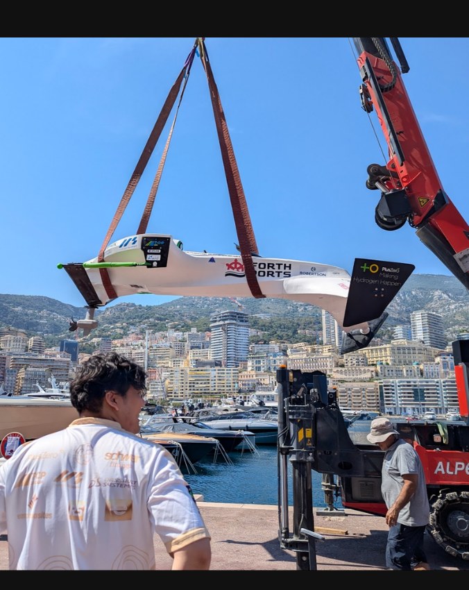 The race boat being craned into Monaco harbour
