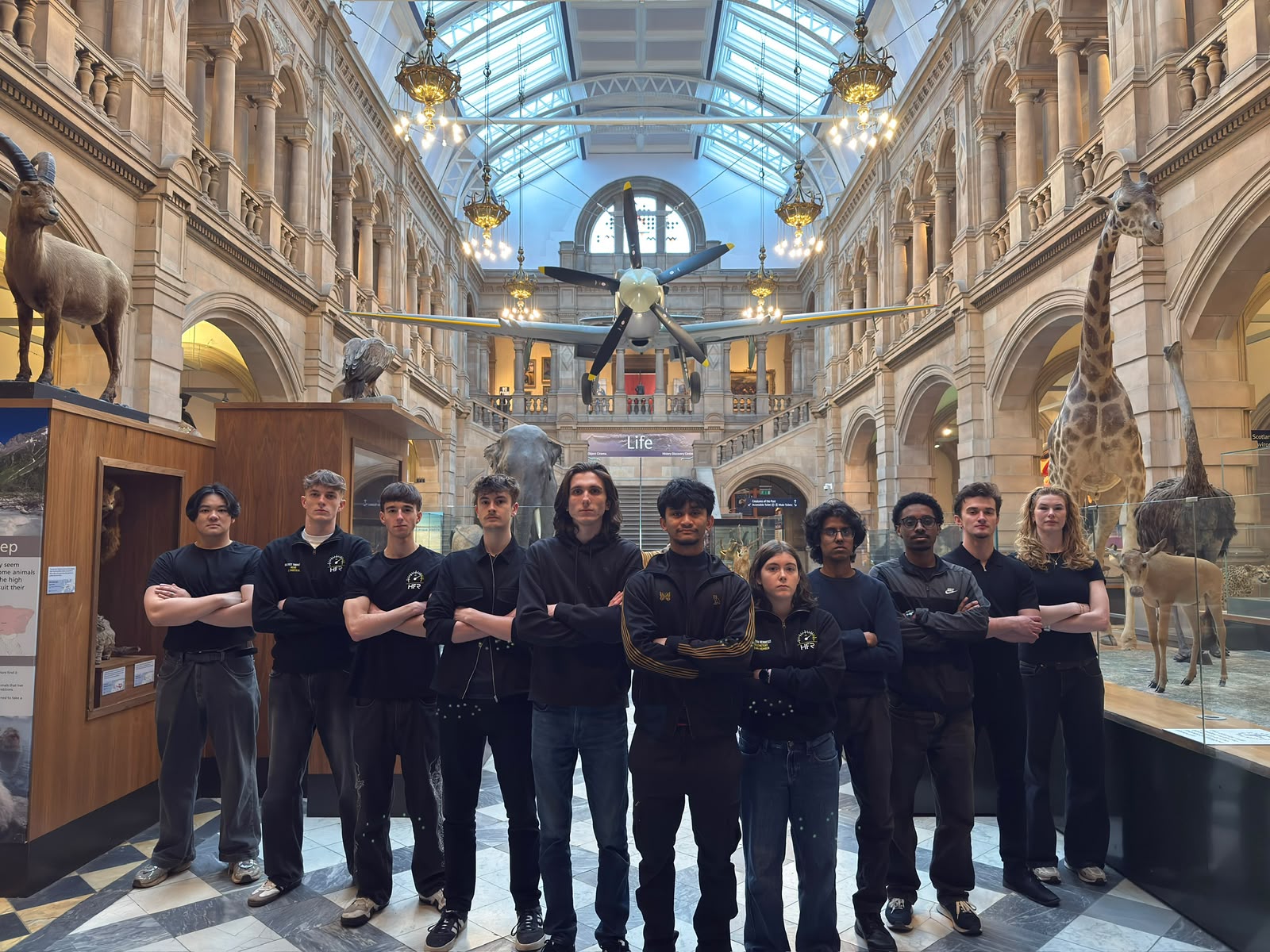 The HFR team beneath the Spitfire at Kelvingrove Art Gallery and Museum